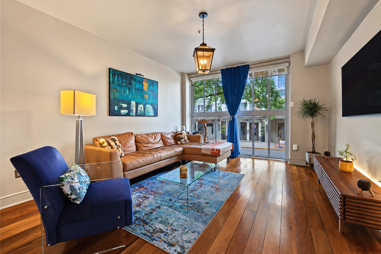 Living room with floor-to-ceiling windows and blue drapes